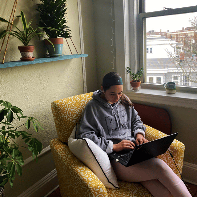 CAPAStudyAbroad_Spring 2020_Working from home_Cara sets up in a comfy chair and pops headphones in-1
