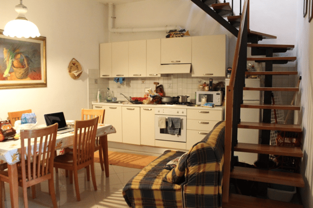 CAPAStudyAbroad_Florence_Spring2018_From Rachel Cholewinski - Apartment Tour_Living Room and Kitchen.png