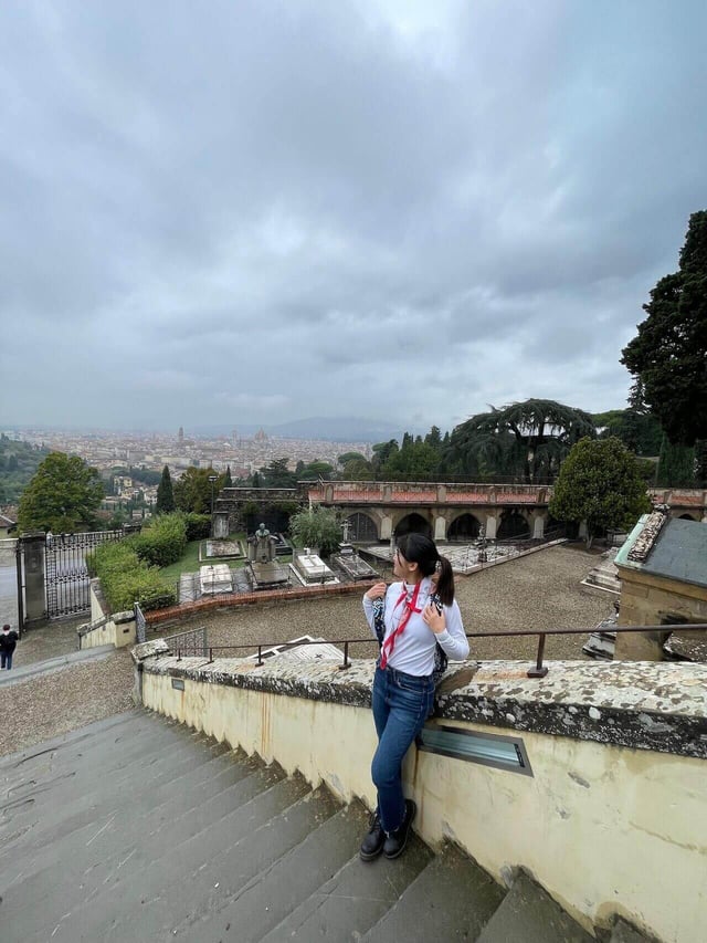 A female student standing on the steps at San Miniato al Monte