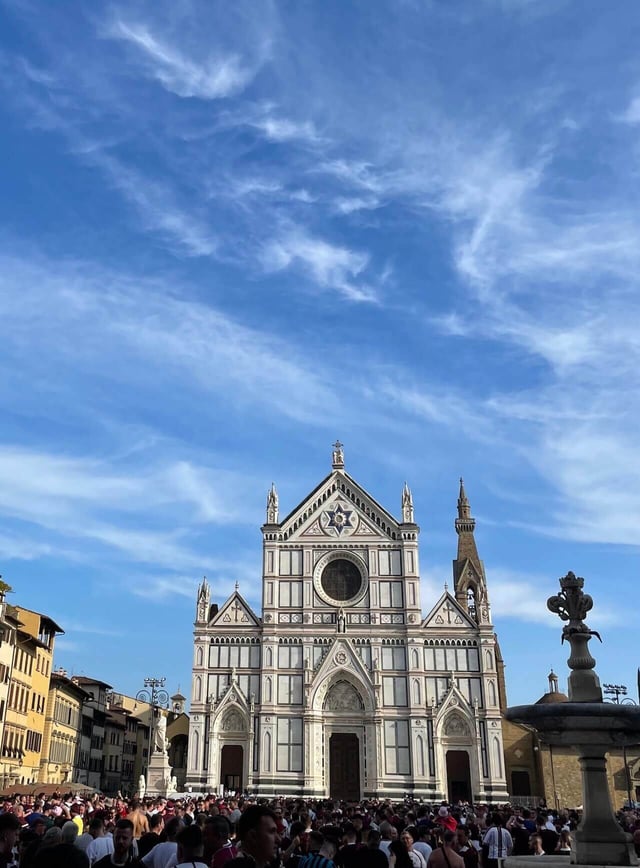 A crowd of people outside Santa Croce in Florence, Italy