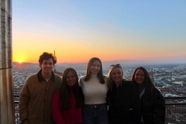 At the top of the Duomo with some friends and a sunset in the back