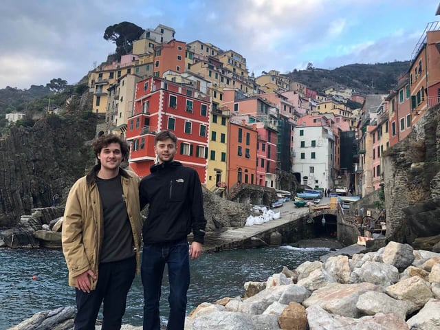 In Cinque Terre with the water, houses, and hills in the background