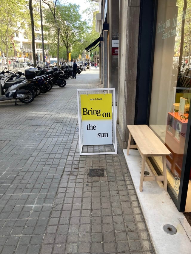 A sidewalk store sign that reads "Bring on the sun"