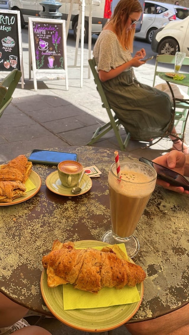 Cold Pistachio Latte and Savory Croissant Sandwich at a cafe in Florence