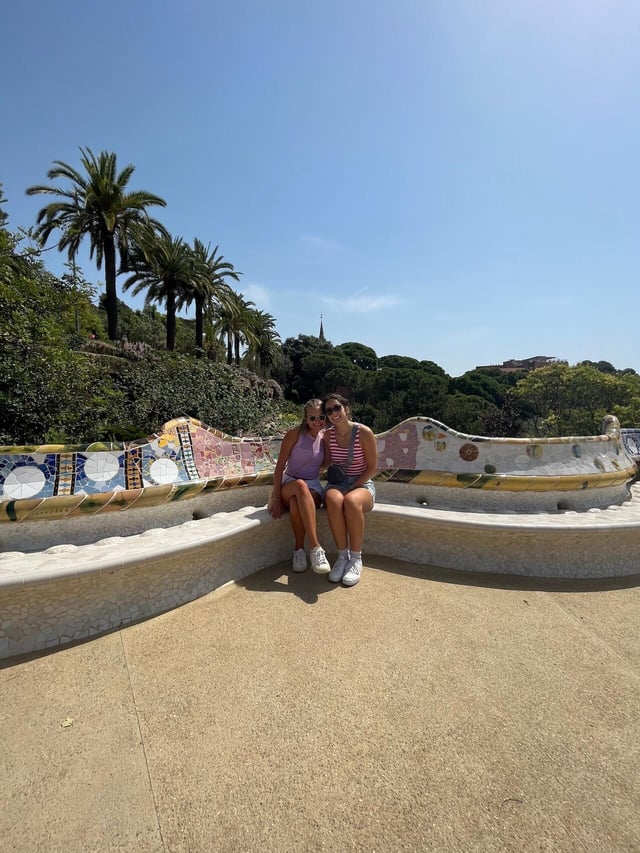 Mia sitting on mosaic benches with roommate Taylor at Parc Guell