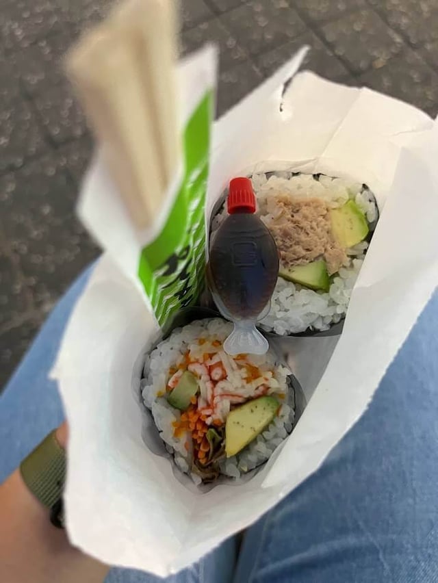 Sushi and wooden chopsticks in a bag