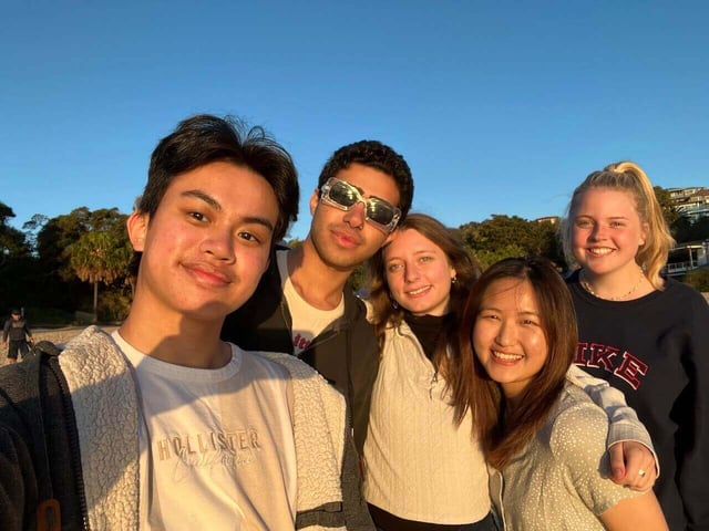 5 students in a group selfie during sunset outdoors