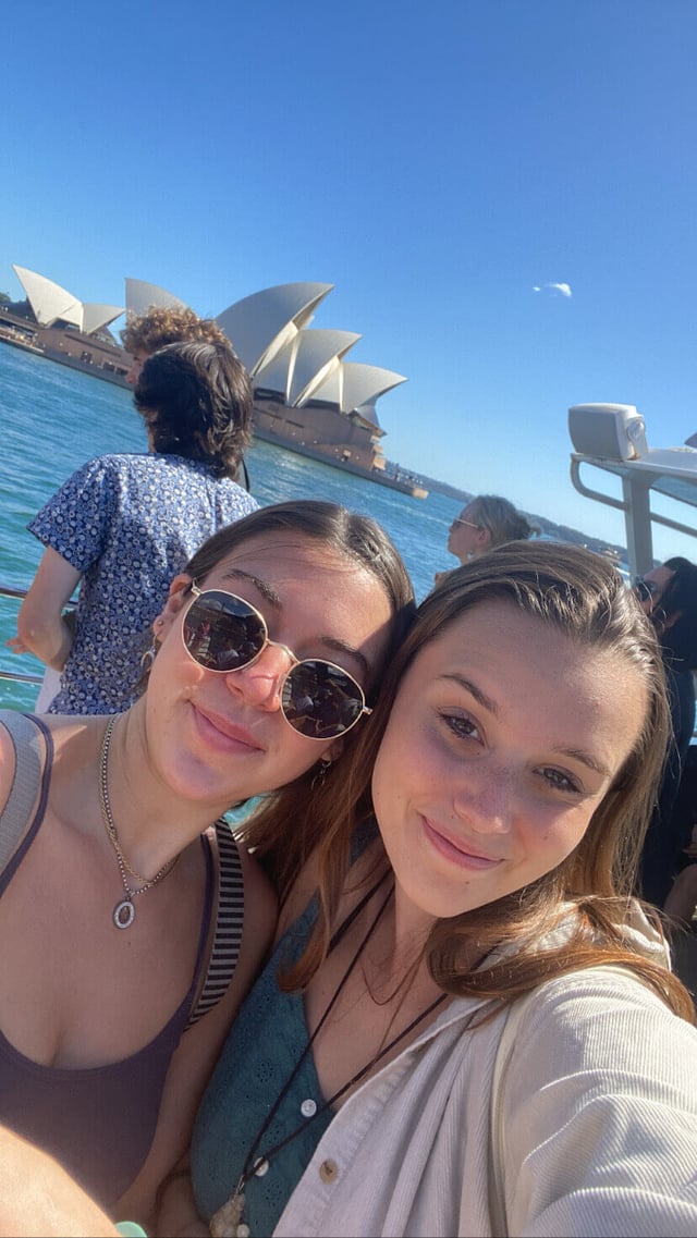 On a boat with a friend in the Sydney Harbour and the Sydney Opera House in the background