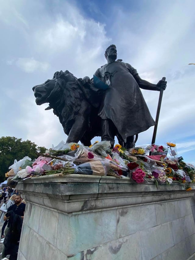 Flowers placed around the Queen Victoria Memorial outside of Buckingham Palace