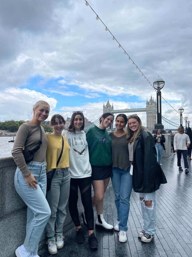 A group of friends in London with Tower Bridge in the background